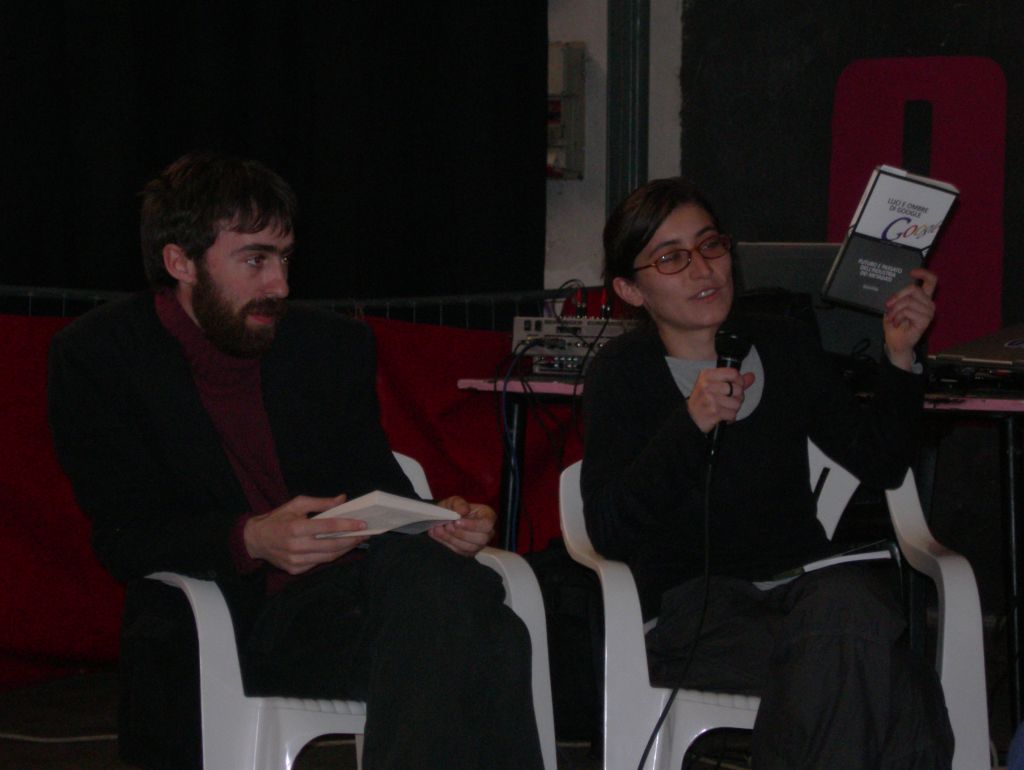 a woman sitting in a chair holding up an ipad