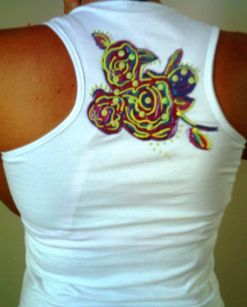 the woman's sleeveless shirt has a flower on it