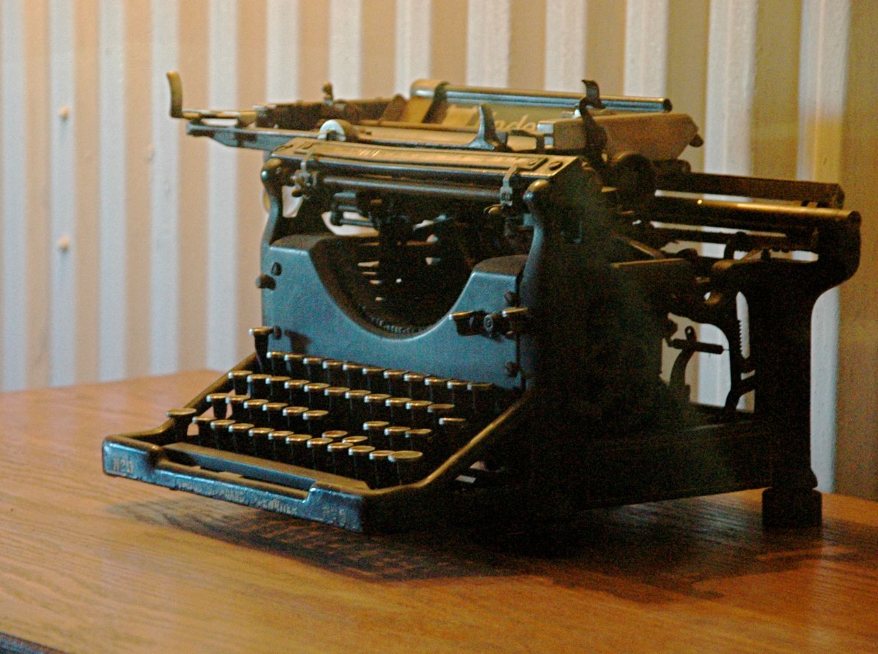 an old - fashioned typewriter is on a desk