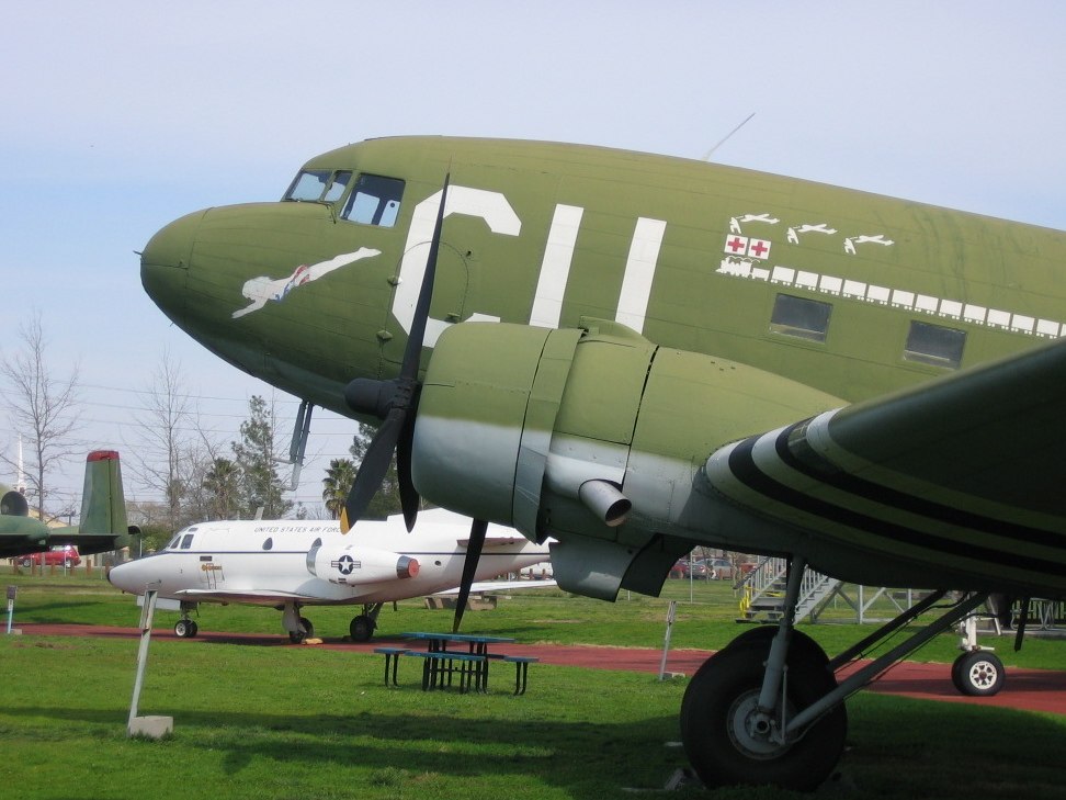 green and white airplanes on display at an air museum