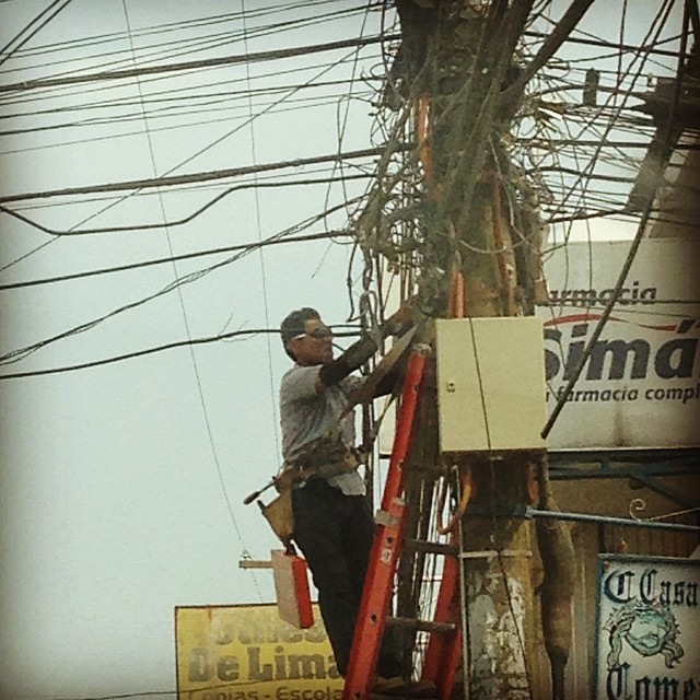a person working on electrical wires in a city