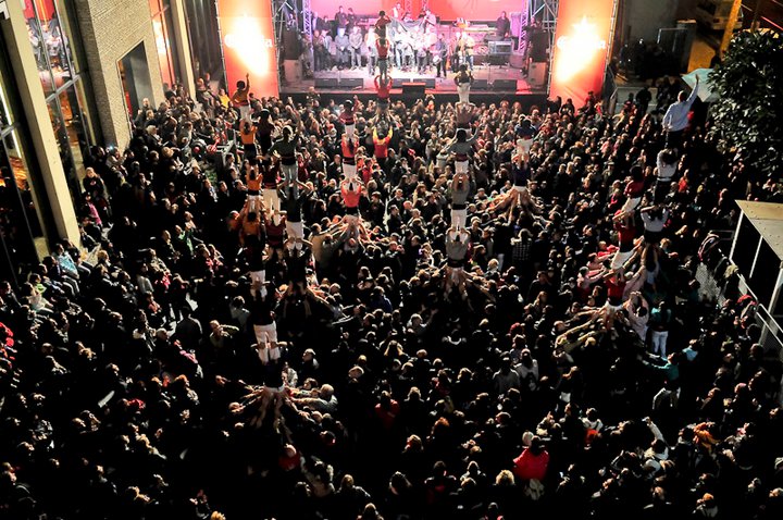 the view of an auditorium from above, looking down on a group of people standing in front of an audience