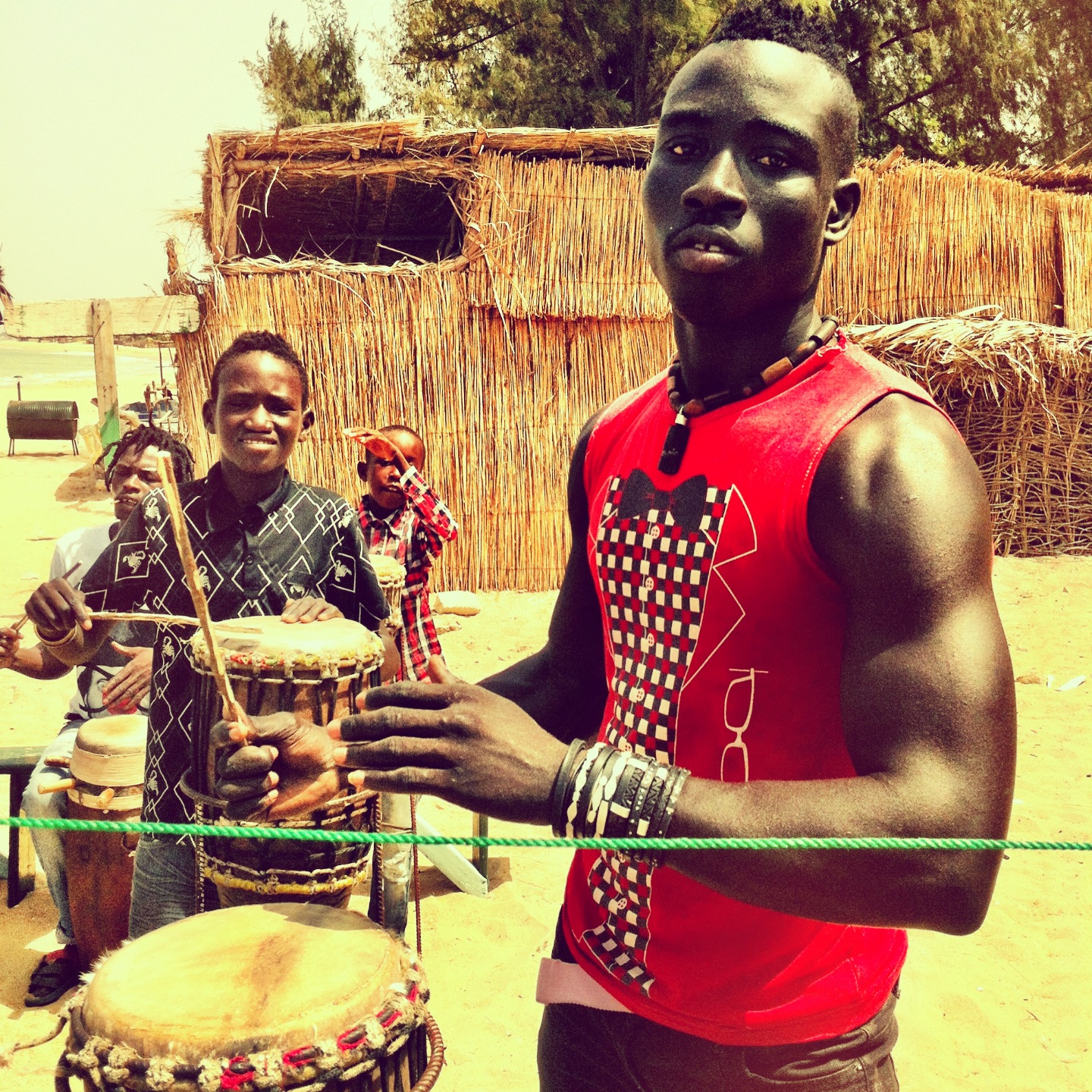 a man with african drums in front of a crowd