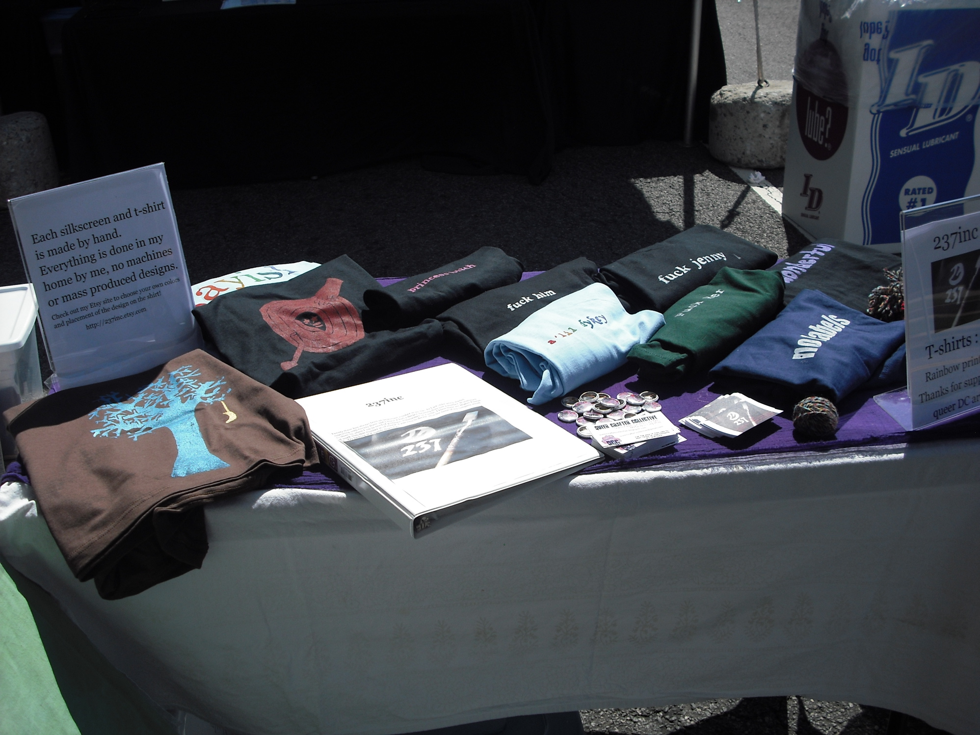 an open book, shirts and t - shirts sitting on a table