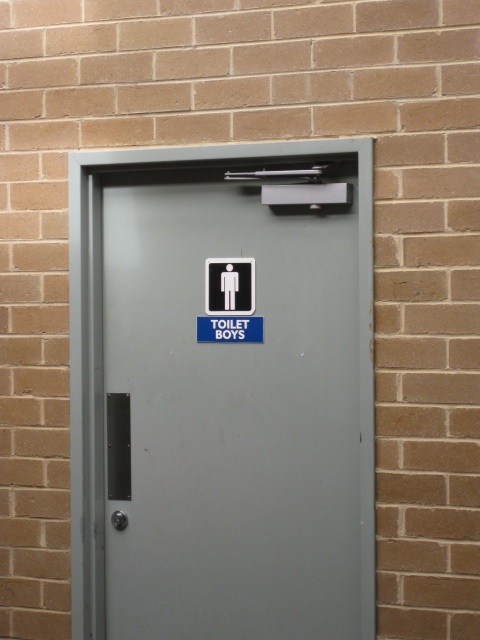 a toilet in a stall with the door open
