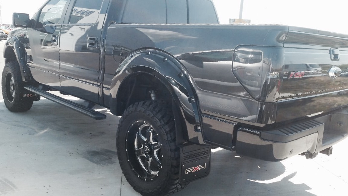 the side view of a truck parked in a lot