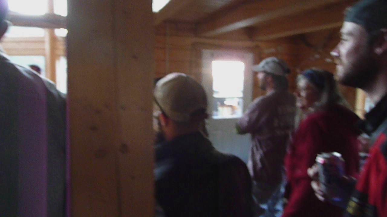 several people are standing in an area with wood beams