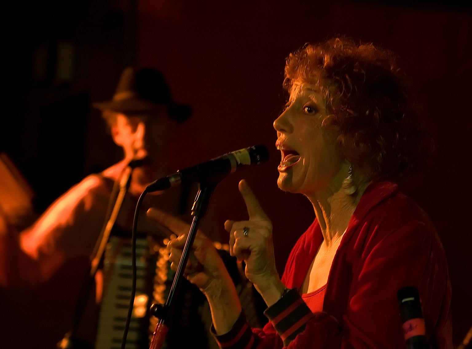 two people playing music on a stage