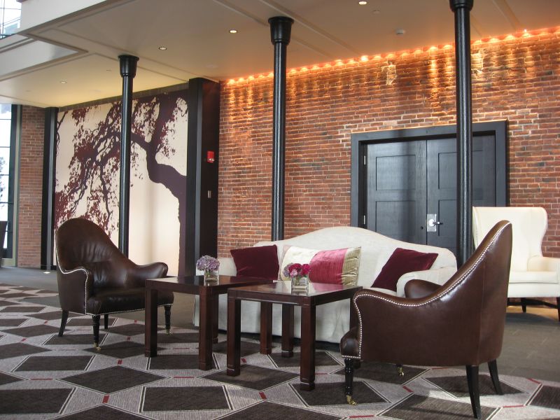 a el lobby with fancy seating and decorative brick