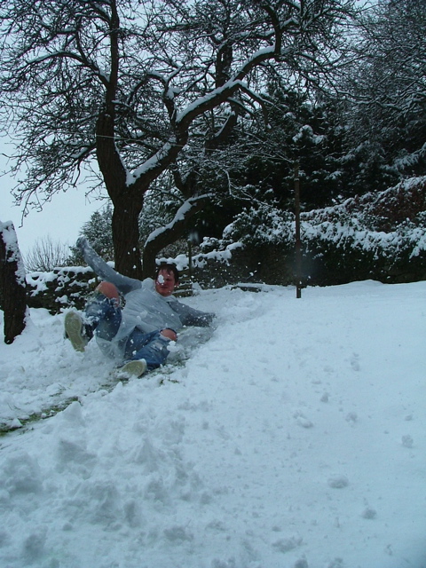 a man sliding down a hill in the snow