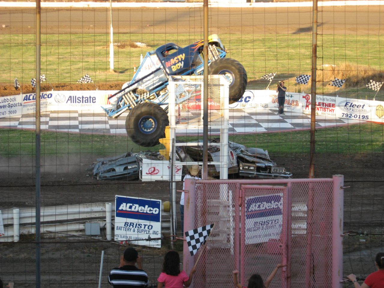 two large vehicles are coming off the track and making their way to the front