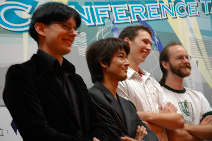 five men stand next to each other near an intel logo