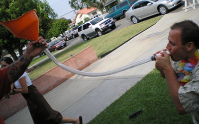 a man playing with a hose and an orange cone
