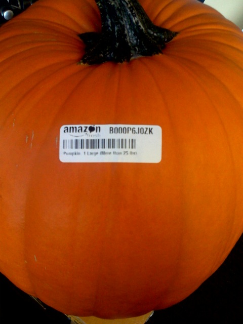 there is a pumpkin that is orange with an amazon sticker on it