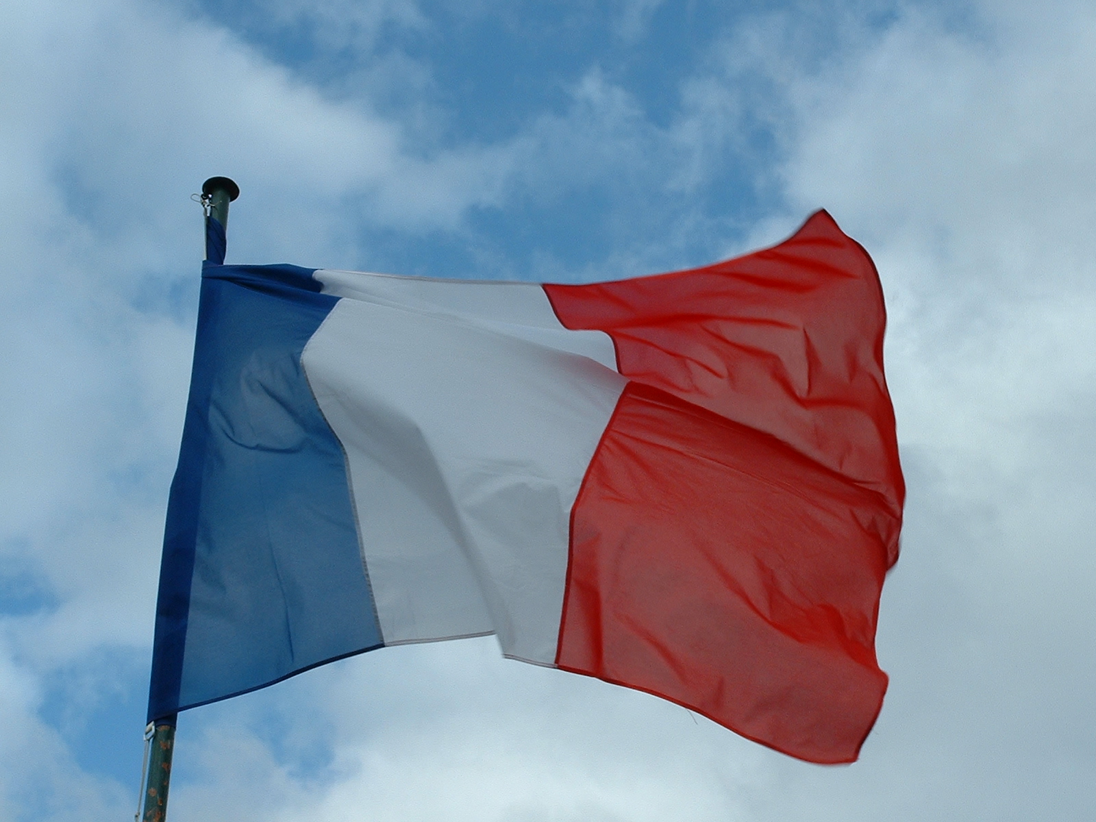 the flag of france is flying in a blue, white and red sky