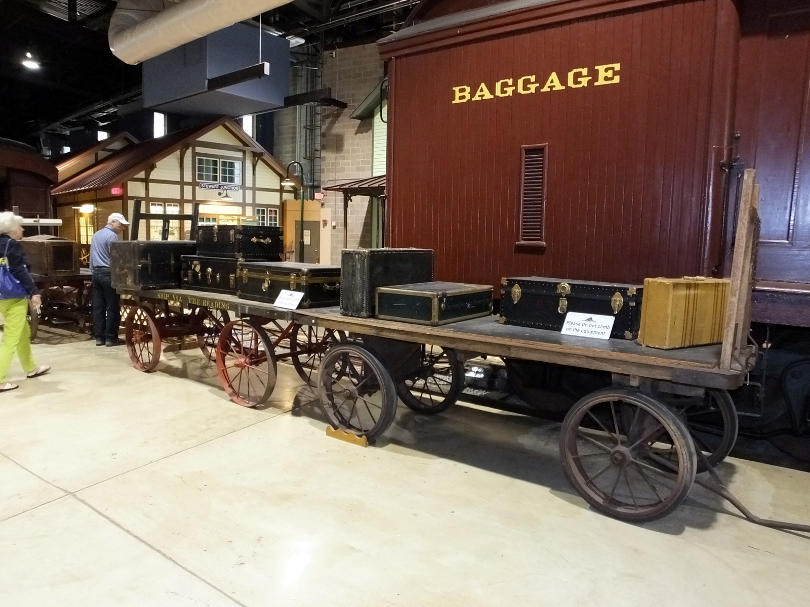 an old train is shown with people around