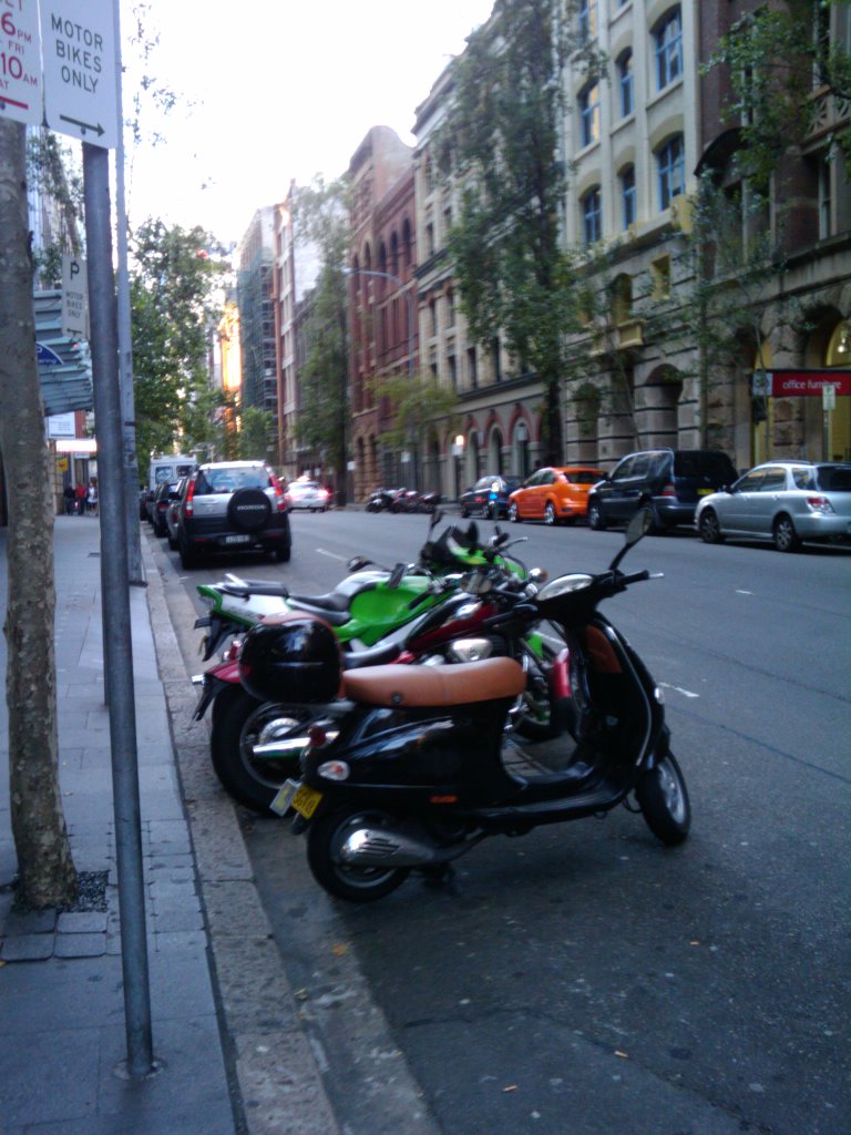 three motorcycles sitting parked on the side of a road