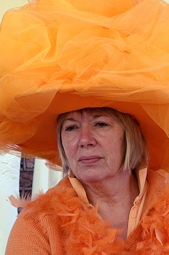 an older woman in a large orange hat