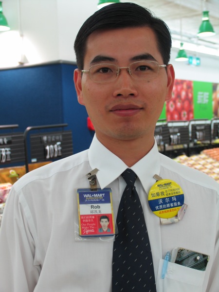 a young asian man wearing white and blue ties and tags