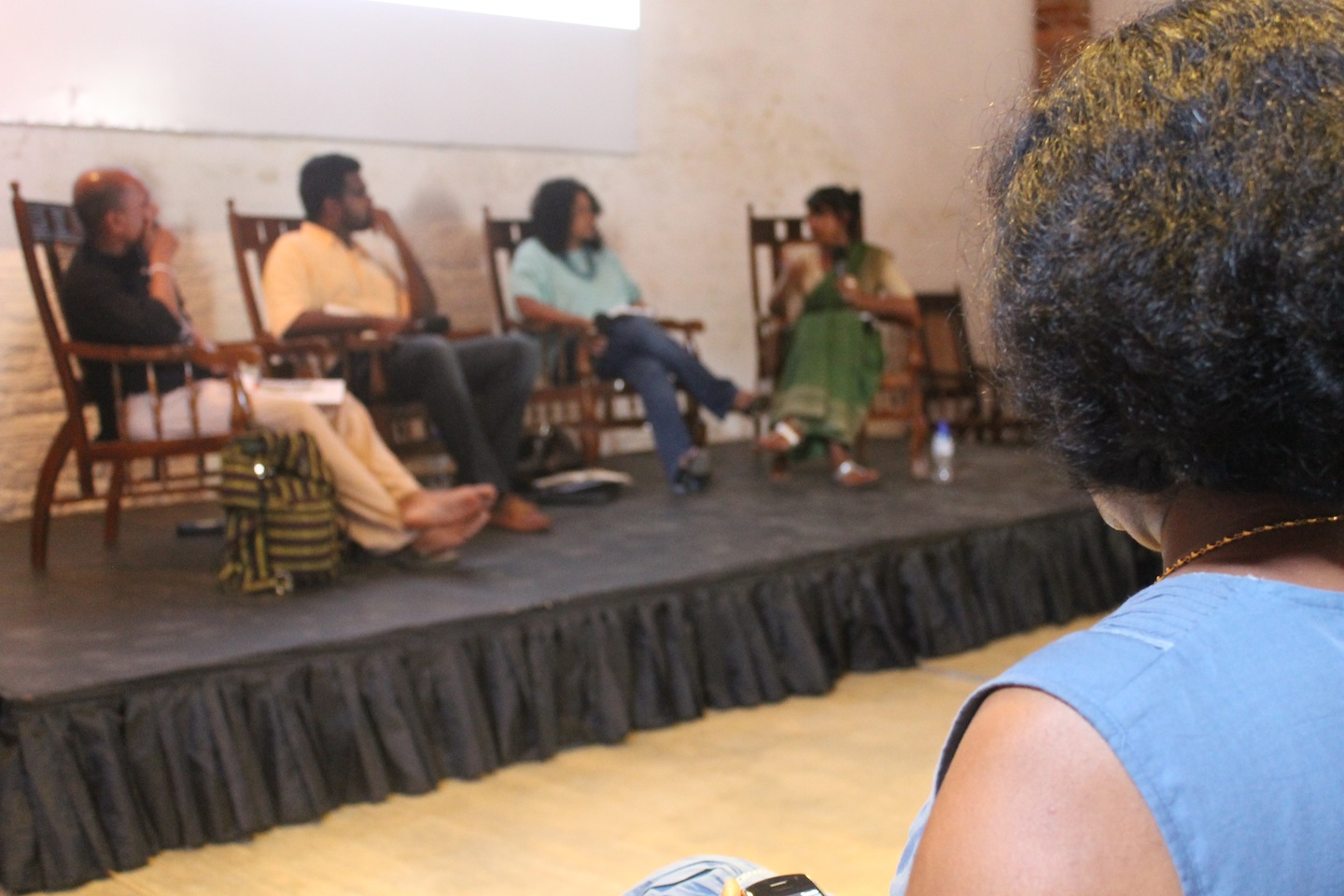 a crowd of people sitting around on stage watching