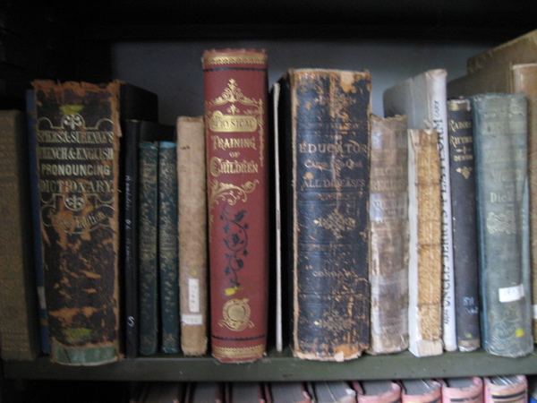 an assortment of books that are sitting on a shelf