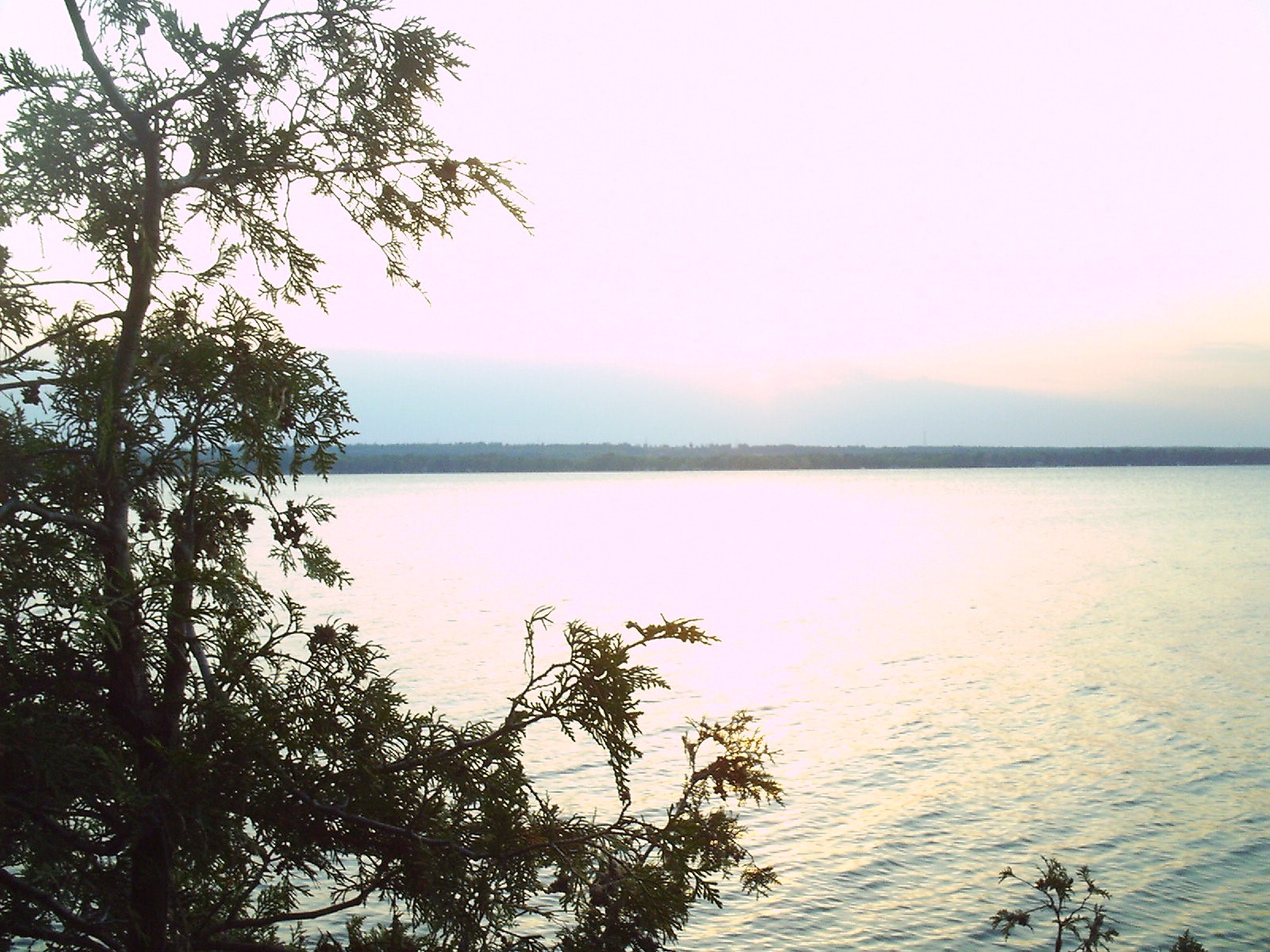 the sun shines on a large body of water