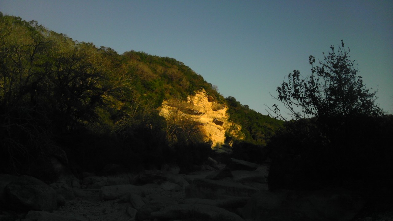 a rocky mountain near the sun setting