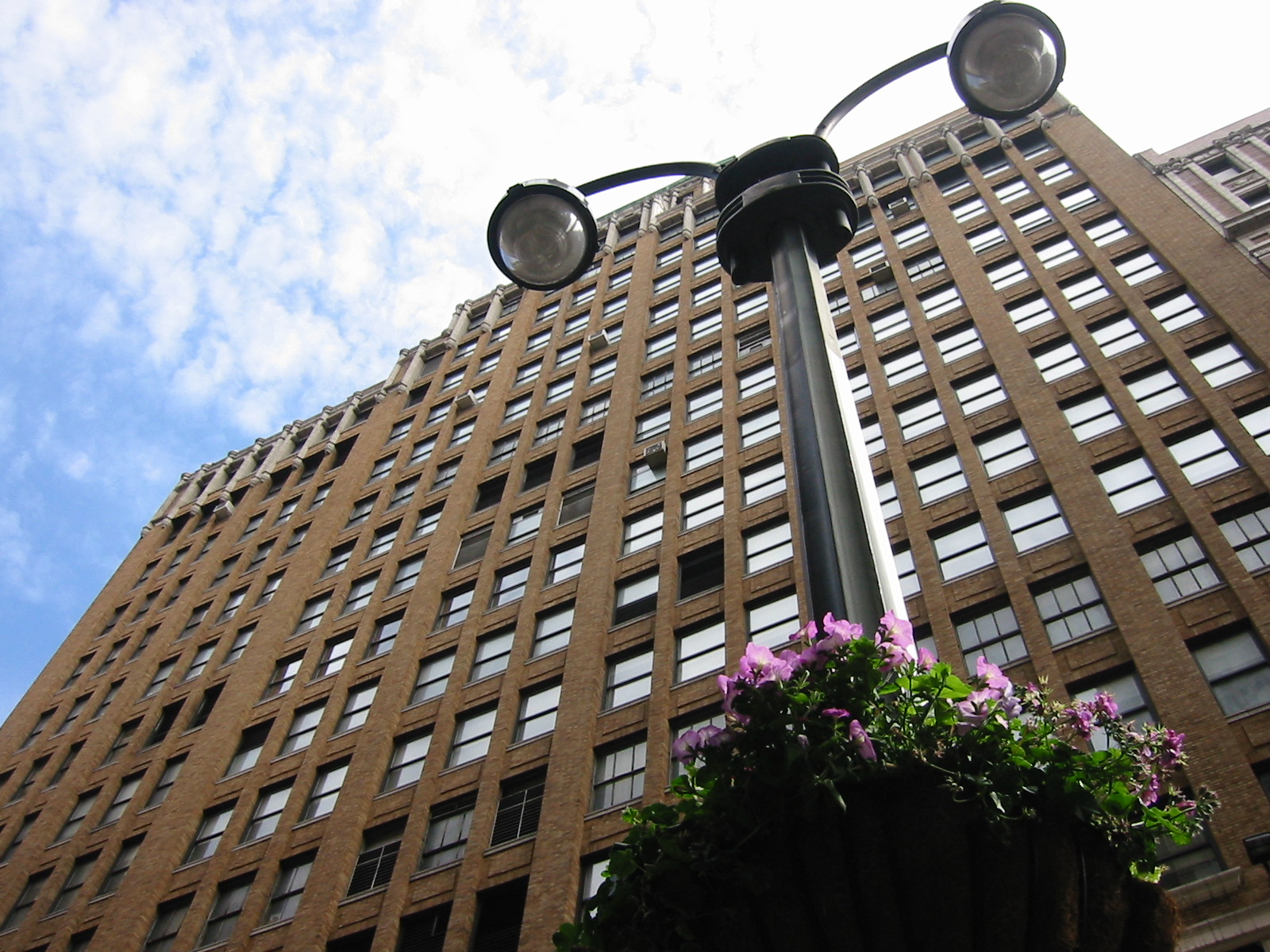 two lights are in the shape of two balls in front of a building