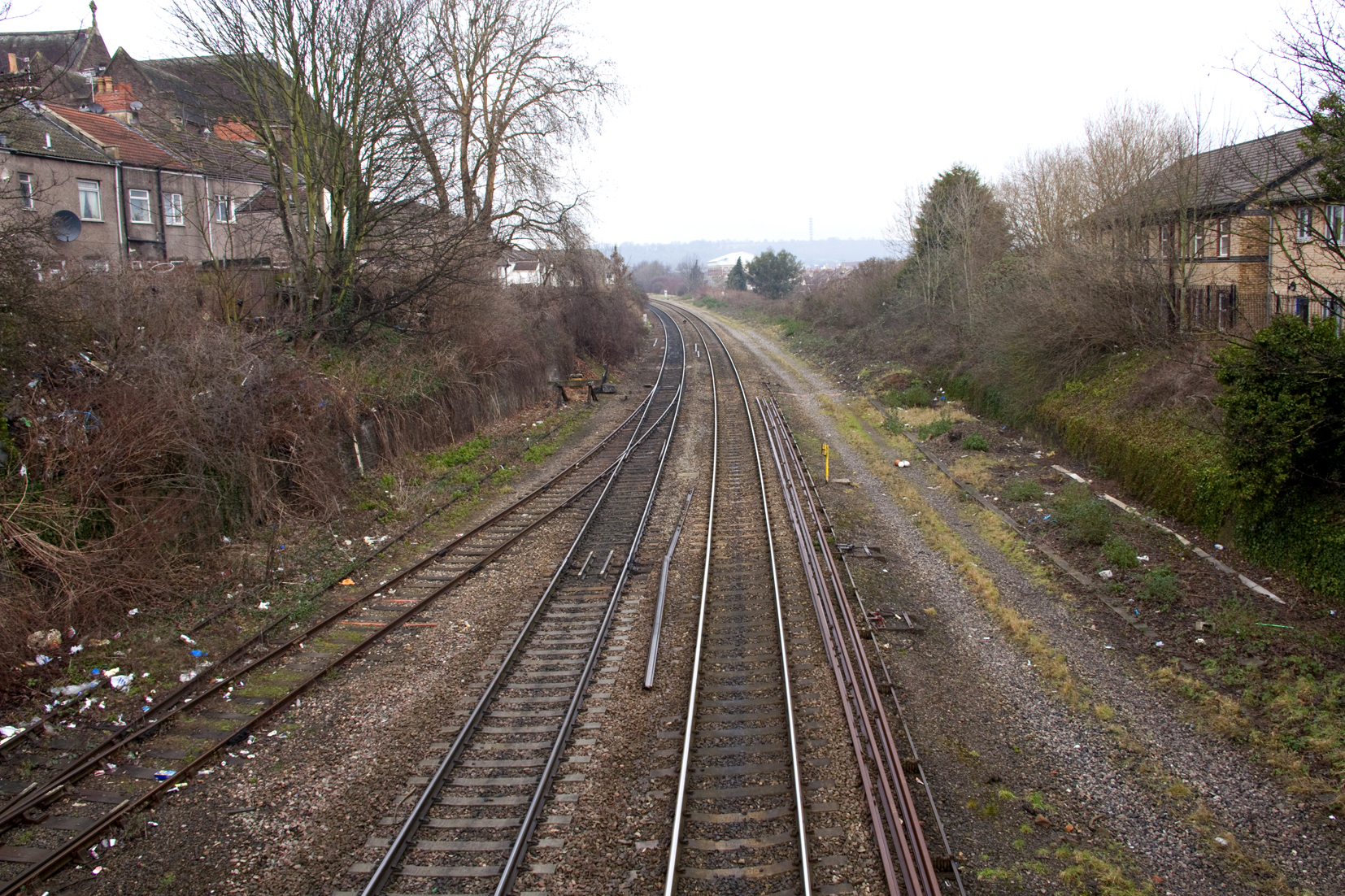 several railway tracks running through a residential area