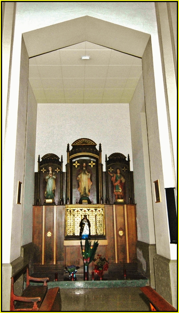 a woman standing in front of a altar with chairs