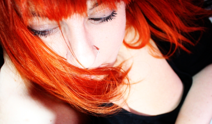 red hair is very bright while the girl has freckled her eyes