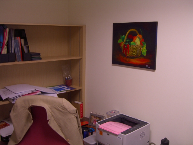an office area with printer, art work area and a chair