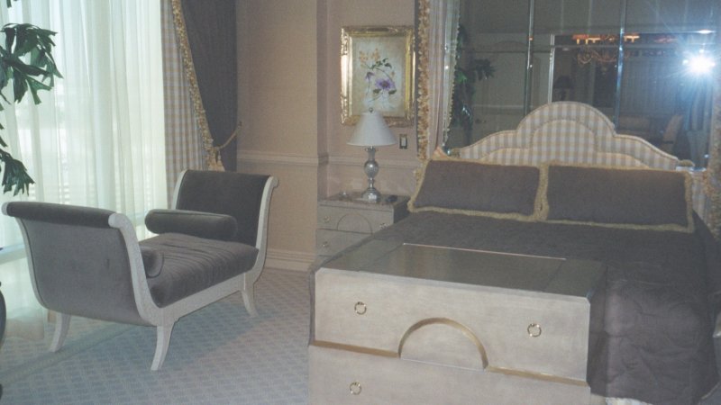 a el room with mirrors and some furniture