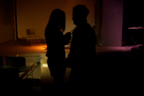 two people that are standing in the dark