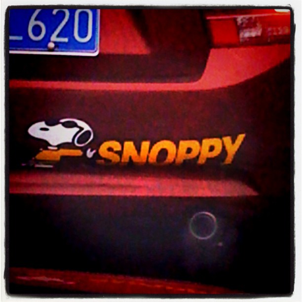 the front end of a vehicle, with a sticker saying snoppy