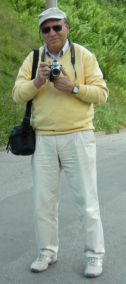 a man is standing in the street holding a camera