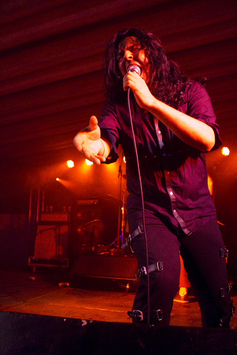 a person on stage singing into a microphone