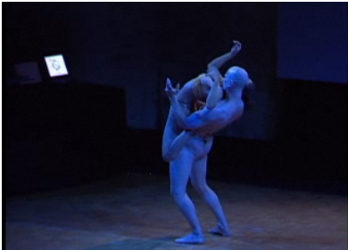 two dancers in white are performing in an empty area