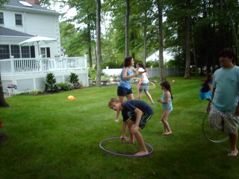 a group of young children playing a game on an inflatable hoop