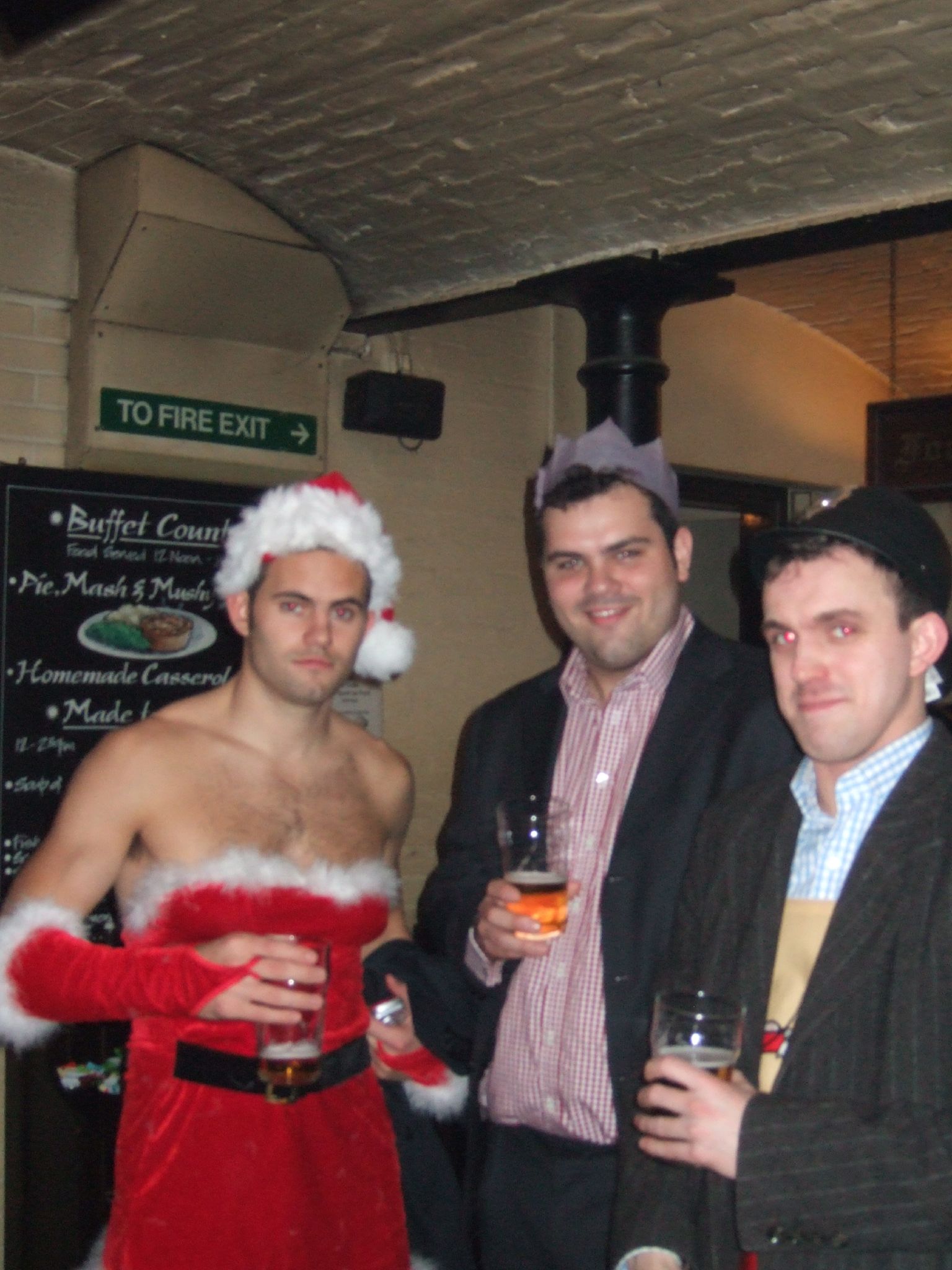 three men dressed in costumes and hats posing for the camera