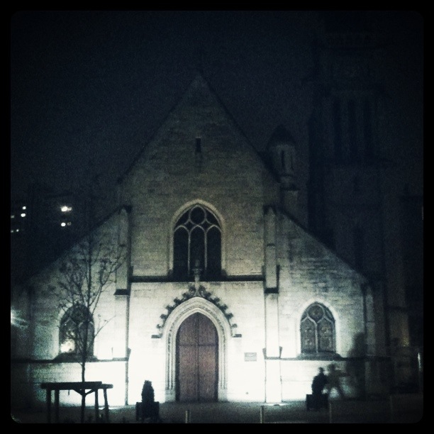 a picture of a church at night with dark lights