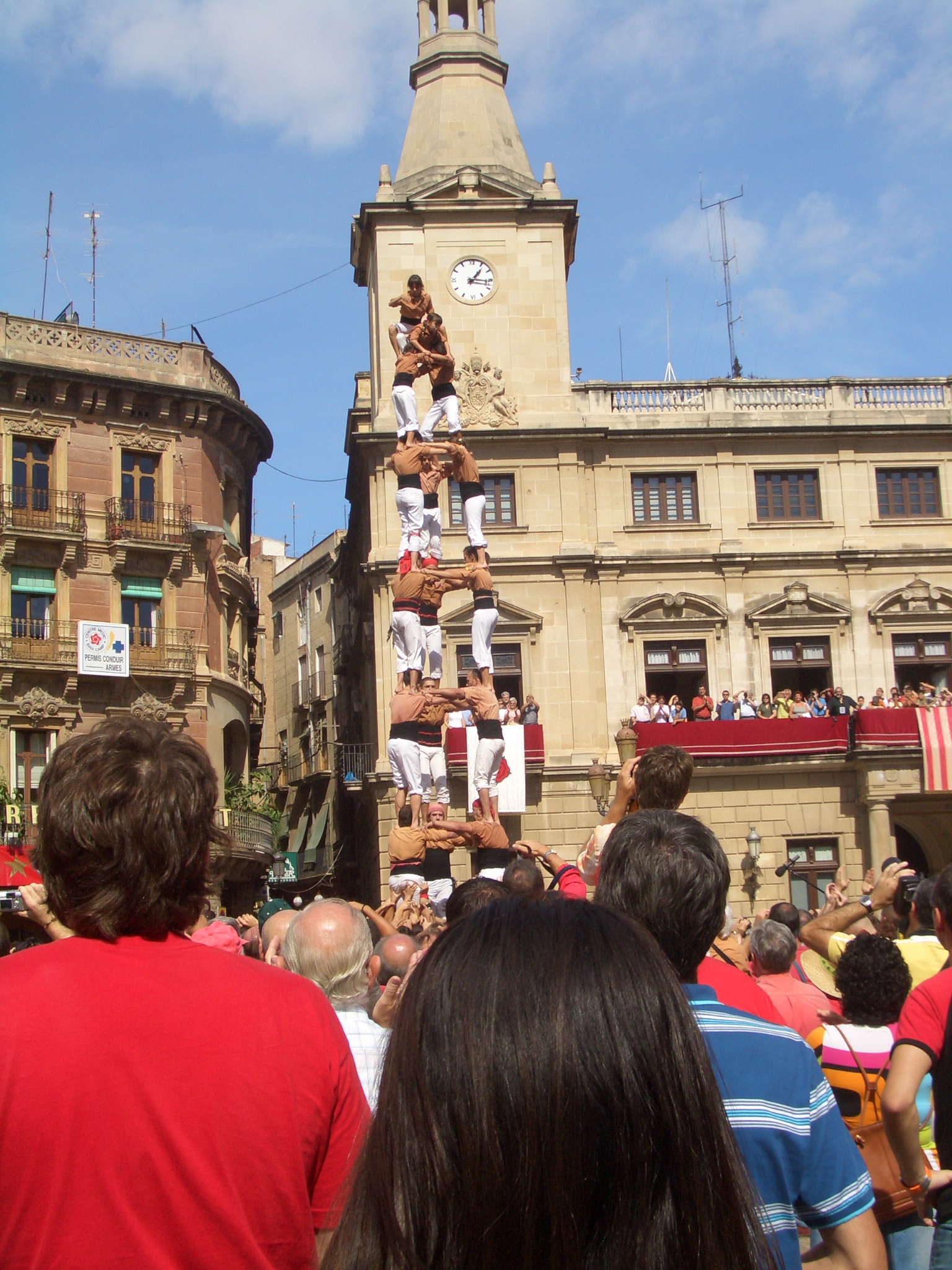 there is a clock tower and many people in the town