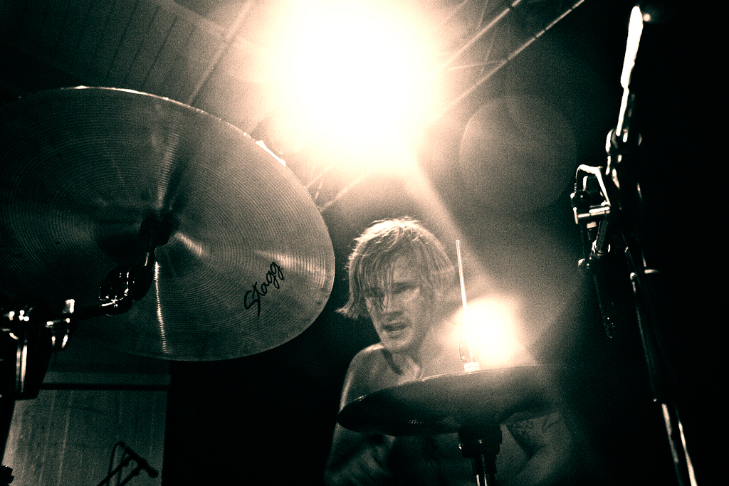 a drummer in front of lights on stage