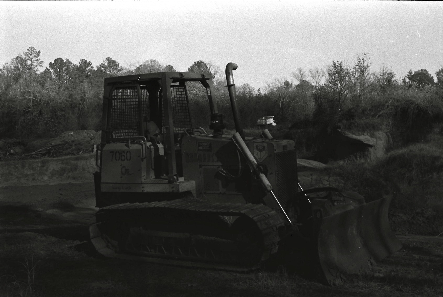 black and white pograph of a bulldozer in the wilderness