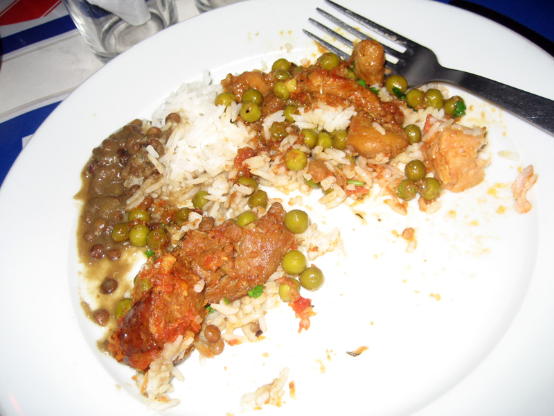 a plate of food containing rice and beans