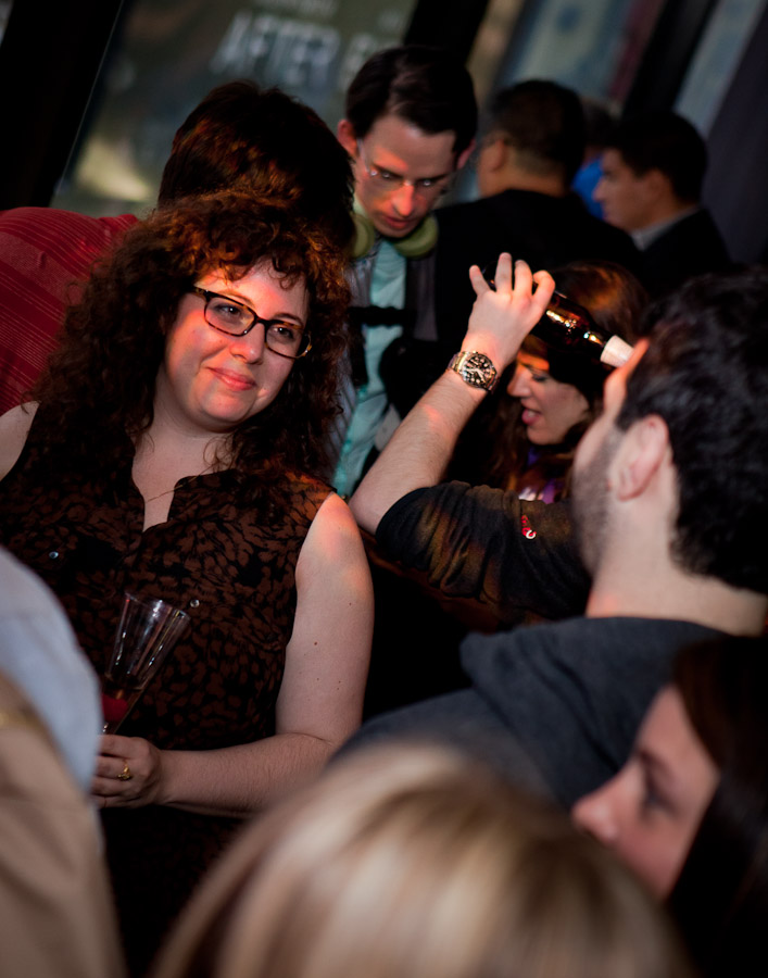 the woman in the brown dress is drinking wine