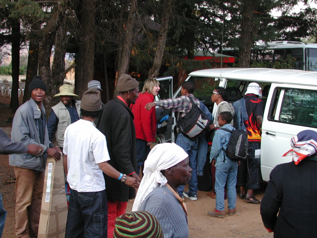 a group of people with a white van