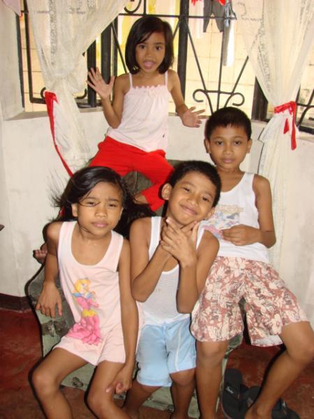 young children standing together and smiling for the camera