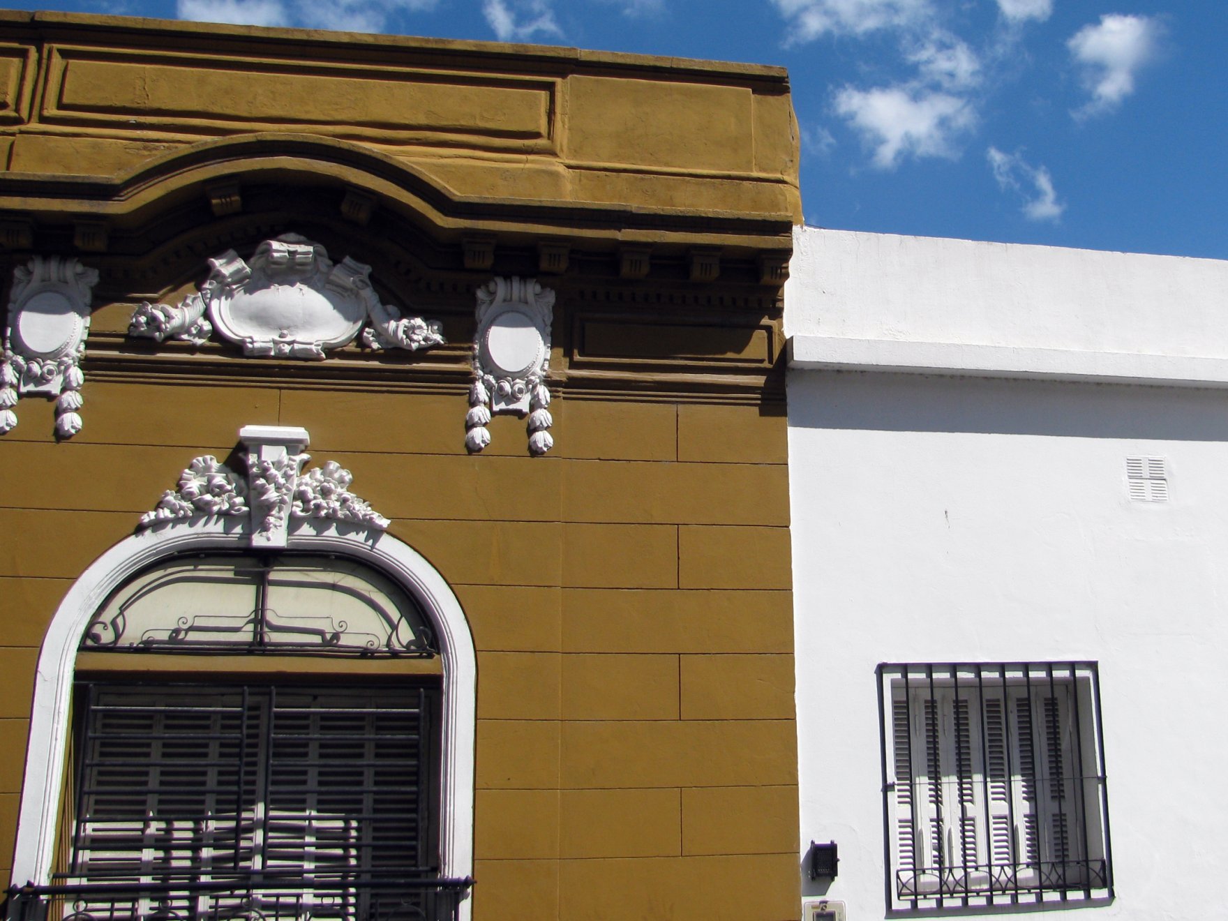 a yellow building with a clock on top