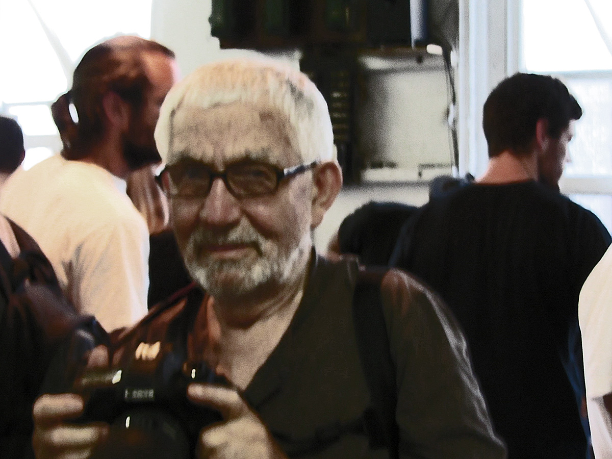a man holding a camera and wearing glasses
